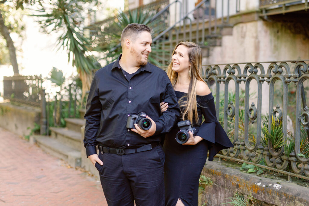 Lead and second photographer's portrait, smiling while holding their cameras