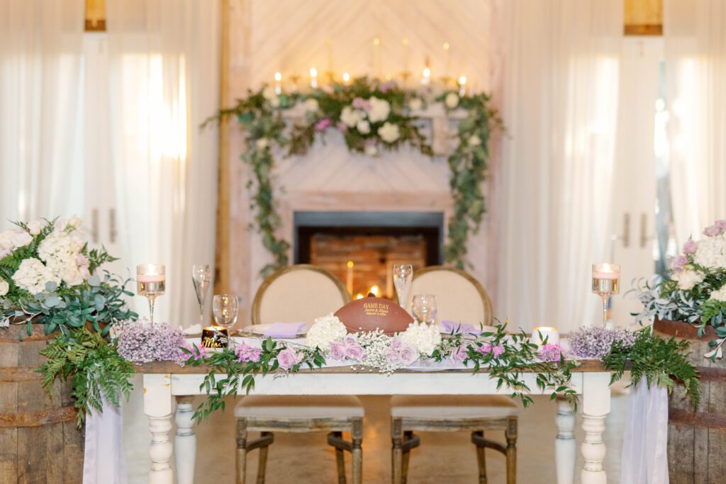 Cut wedding cost by reusing your florals!! Beautiful floral head table at a reception. 