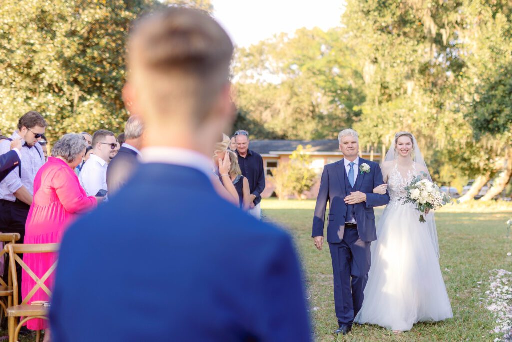 Bride walks down the aisle to her groom 