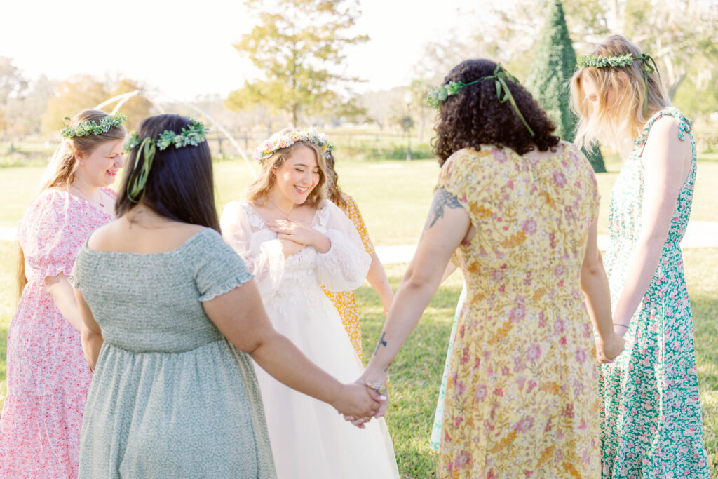 Bridesmaids pray over Bride, supporting each other.